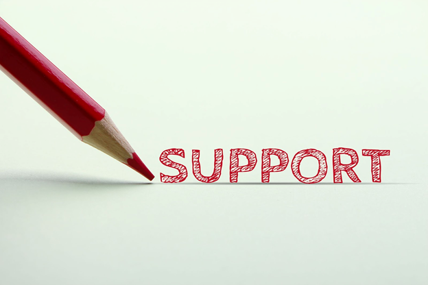 Stock photo of the word "SUPPORT" being sketched on the page with a red pencil